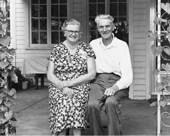 Elder couple in front of house