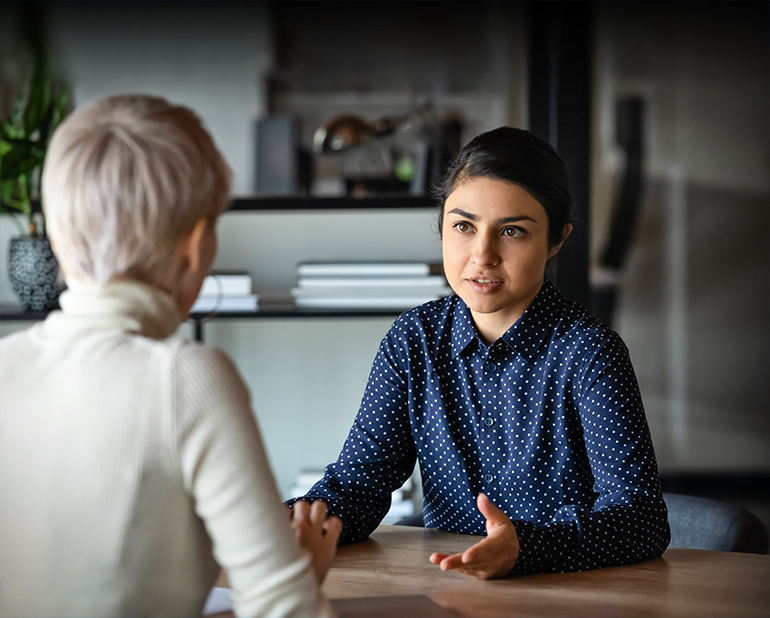 women talking in office image