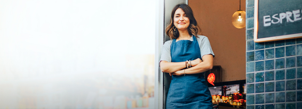 women smiling outside of a business establishment